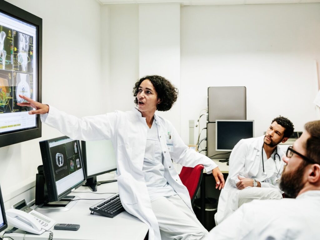 Researchers looking at data on a screen
