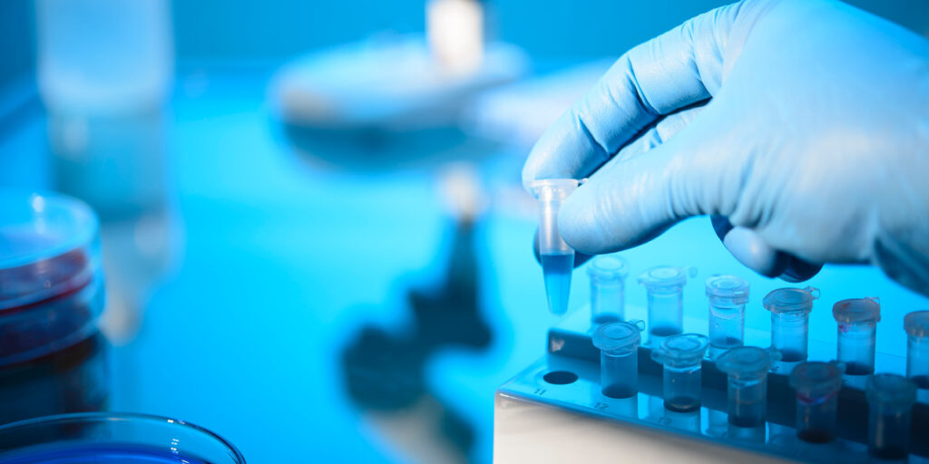 Image of researcher holding a centrifuge tube representing the testing standards