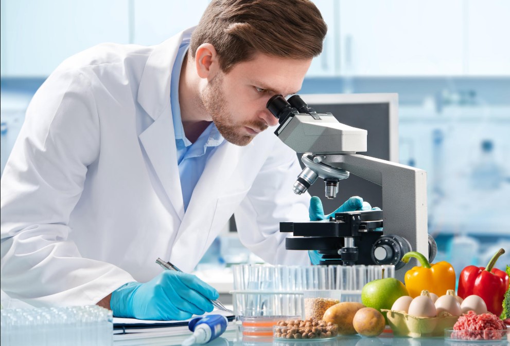 imageof a scientist looking through a microscpoe