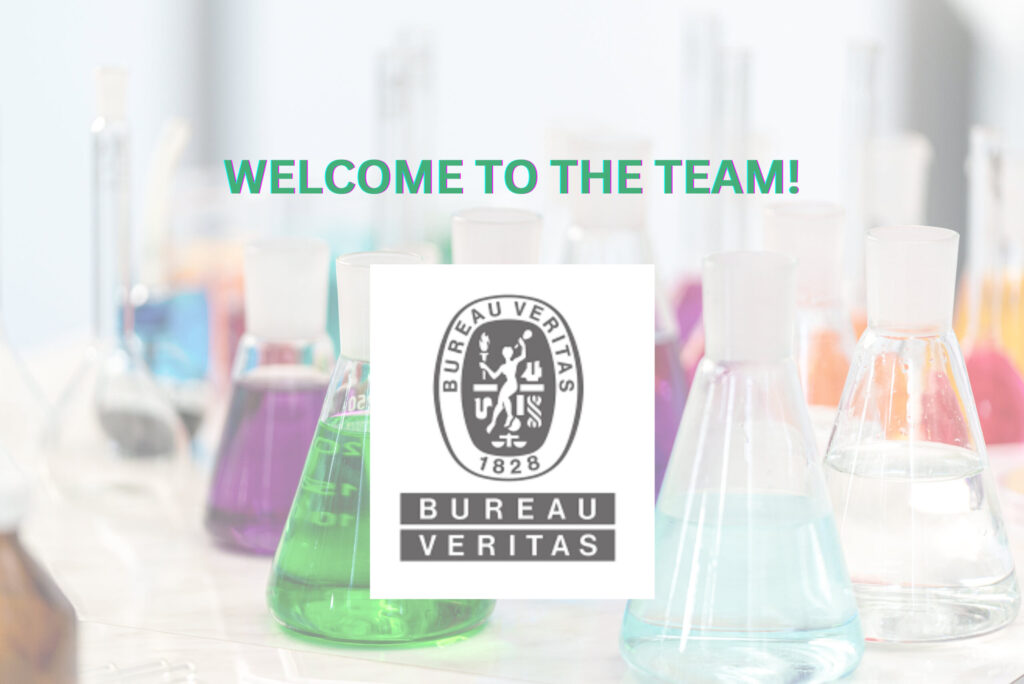 Several conical flasks filled with colored liquids on a lab bench with Bureau Veritas logo in the foreground.