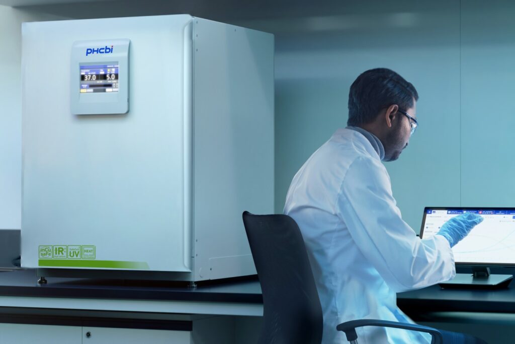 New incubator in a lab next to a researcher