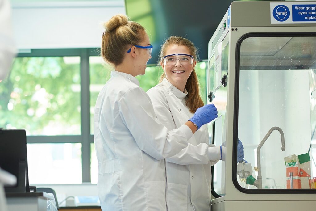 Two young researchers using ductless fume hoods