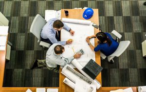 image taken from above of people working at a boardroom table