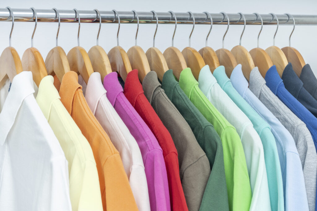 multiple mends shirts ov various colors hanfing n a rail illustrating the idea of color and color-fastness testing