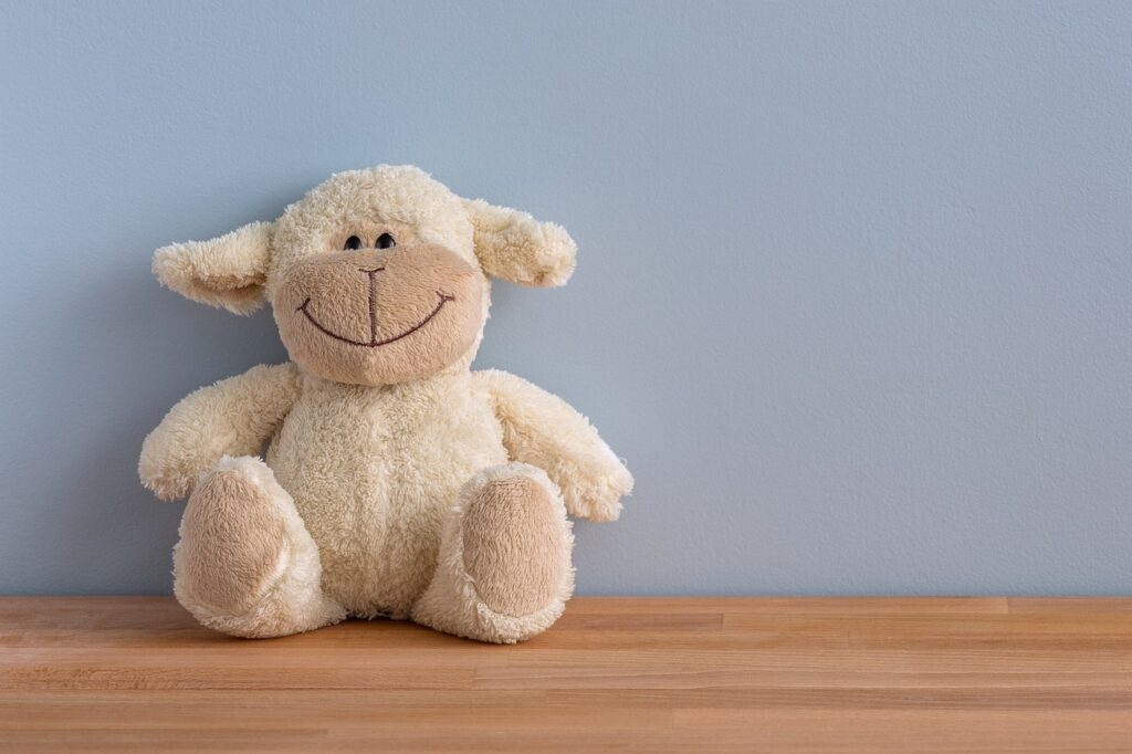 Image of stuffed toy sitting on wooden bench