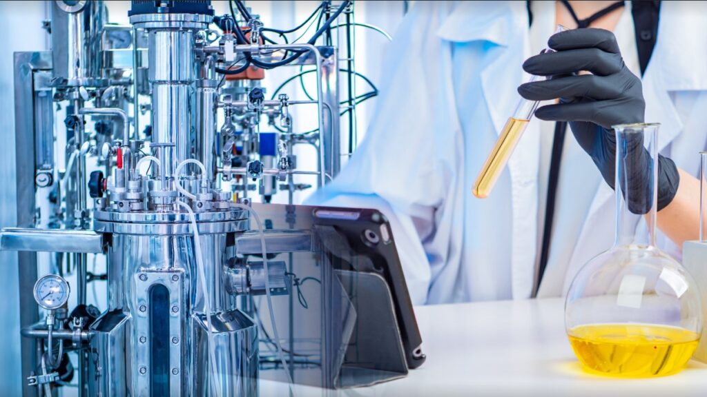 image of a scientist working with a bioreactor ina lab showing the significance of bioprocessing in industrial microbiology