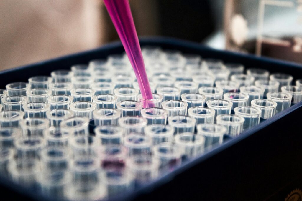 Close-up of pipetting liquid into tubes.